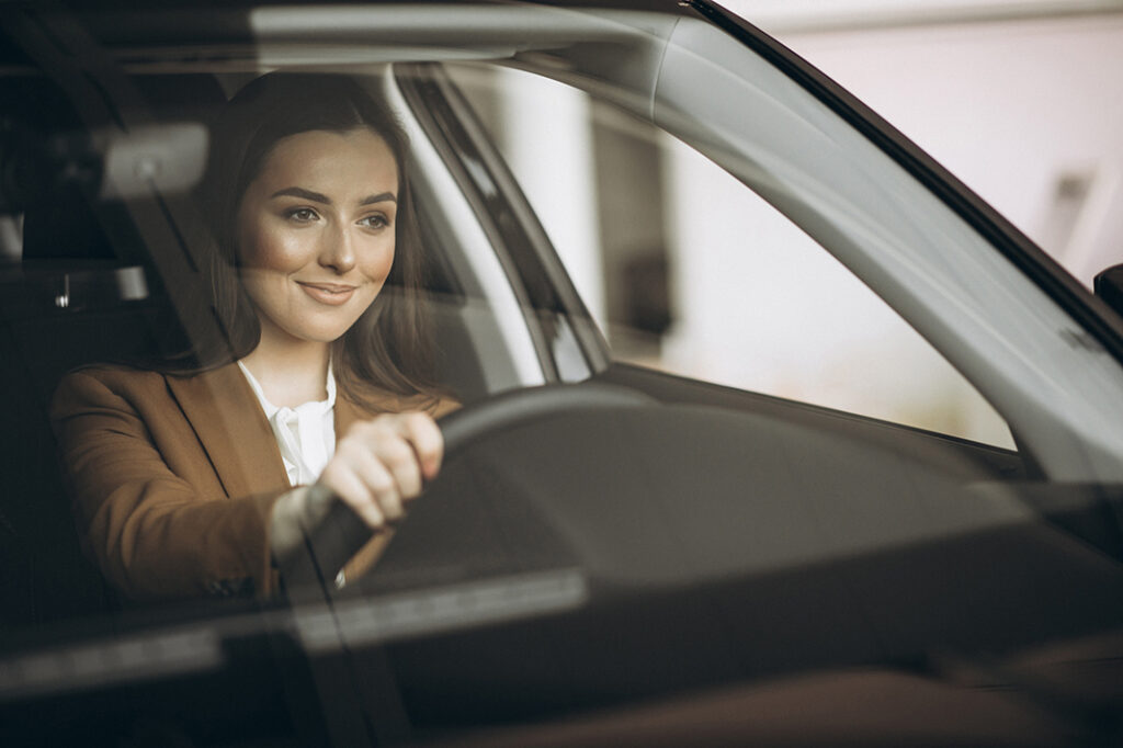 Young business woman sitting in car